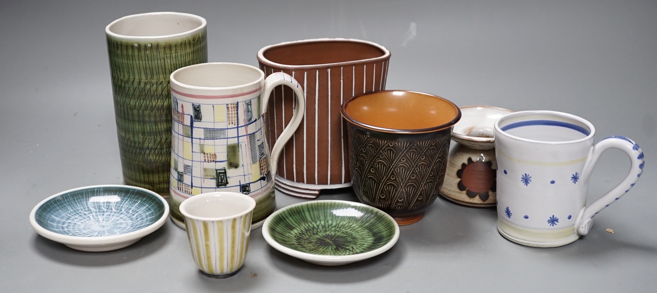 Seven pieces of Rye pottery to include a Dennis Townsend marked mosaic tankard, another small star and dot mug, two sgraffito pin dishes, a Jim Elliot marked terracotta pot, a cylindrical brush pot and a yellow striped t